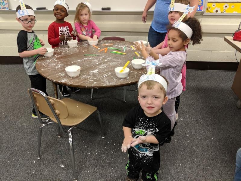 Group photo of students with cornstarch mess